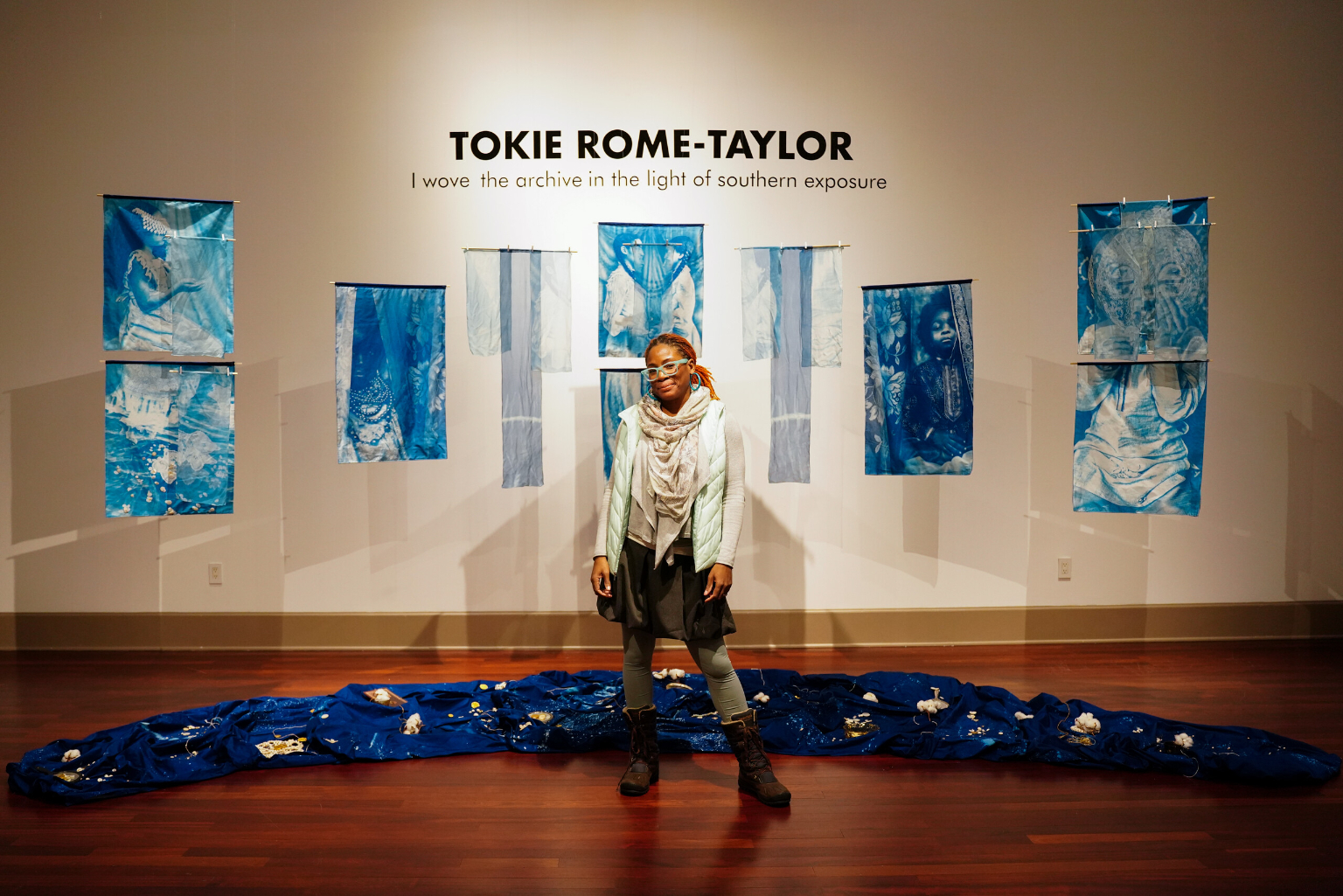 artist stands in front of her multimedia artwork