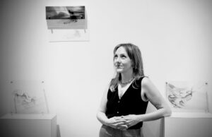 Lybi Cucurullo stands in front of hermultimedia artwork